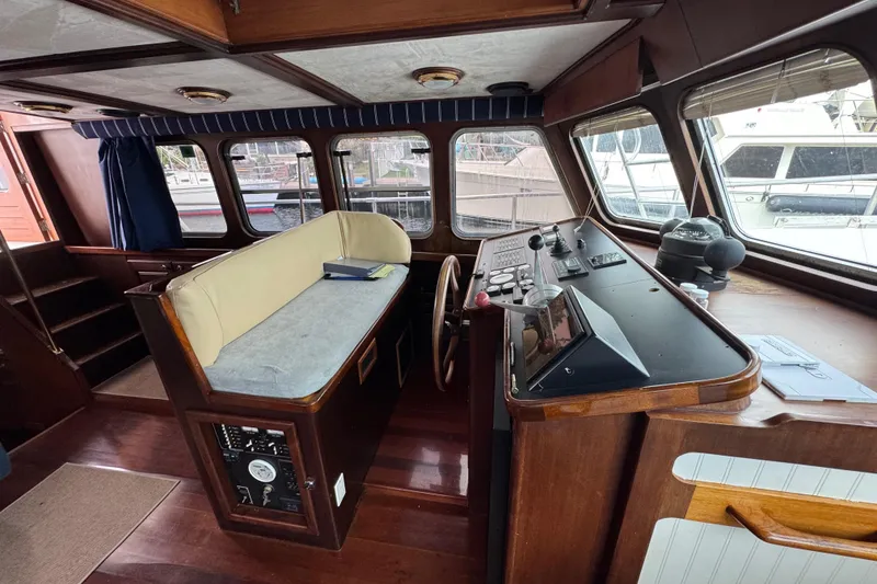 Slide: The Image of Interior of 1982 Custom Virpack Steel Hull boat with wooden helm and seating area. - 14