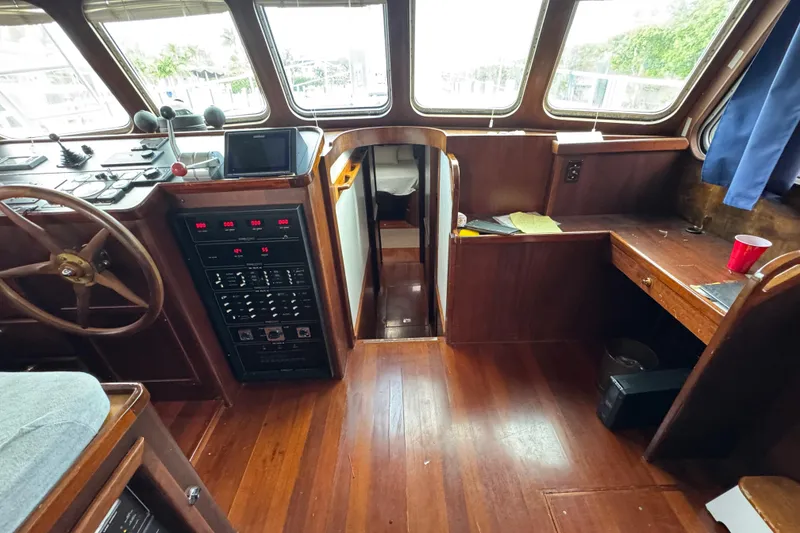 Slide: The Image of Interior of 1982 Custom Virpack Steel Hull boat with wooden flooring and control panel. - 17