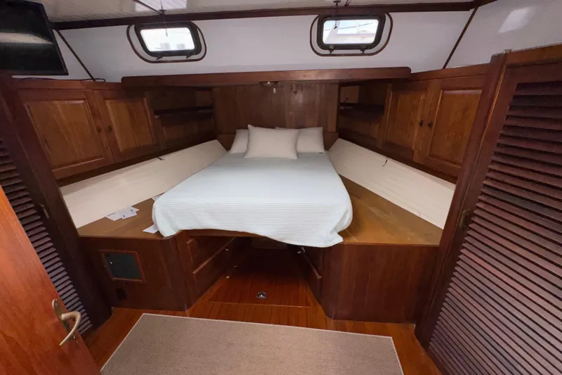 Slide: The Image of Cozy cabin interior of 1982 Custom Virpack Steel Hull with wooden furnishings and bed. - 22