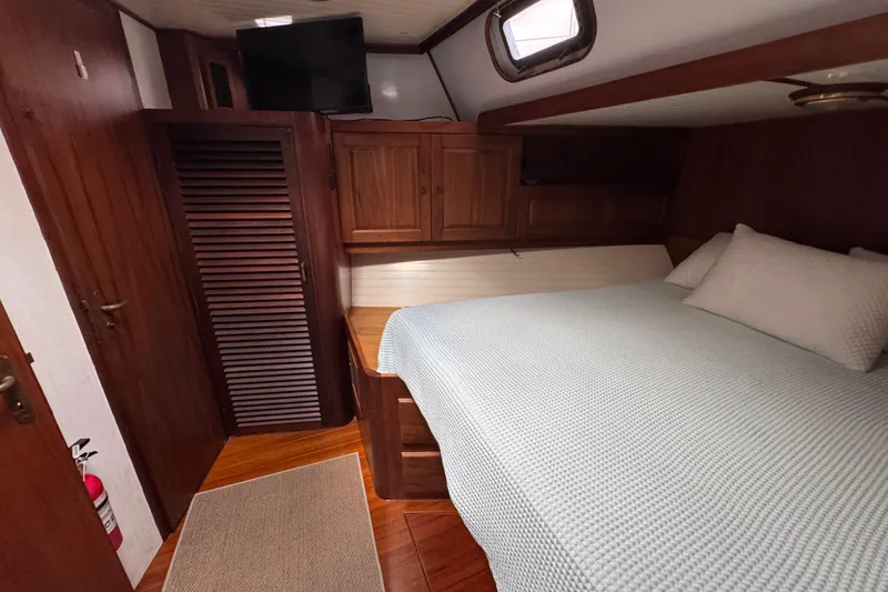 Slide: The Image of Cozy cabin interior of 1982 Custom Virpack Steel Hull with wooden furnishings and a comfortable bed. - 23