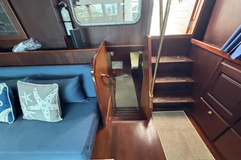 Slide: The Image of Interior of 1982 Custom Virpack Steel Hull boat with wooden stairs and blue seating. - 25