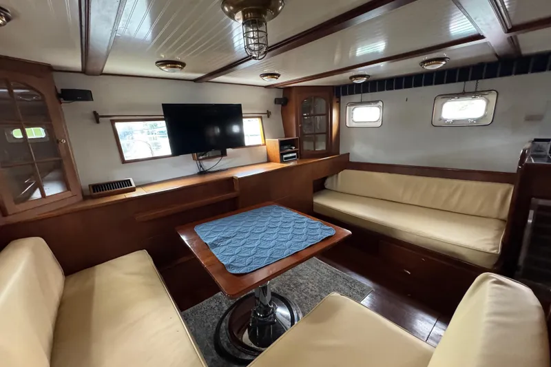 Slide: The Image of Interior of 1982 Custom Virpack Steel Hull boat with cozy seating and mounted TV. - 29