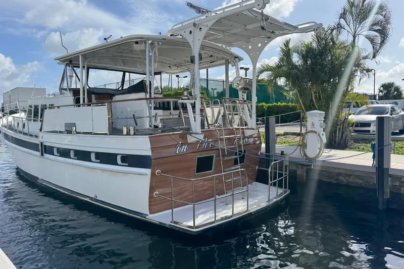 Slide: The Image of 1982 Custom Virpack Steel Hull yacht docked by palm trees under a blue sky. - 3