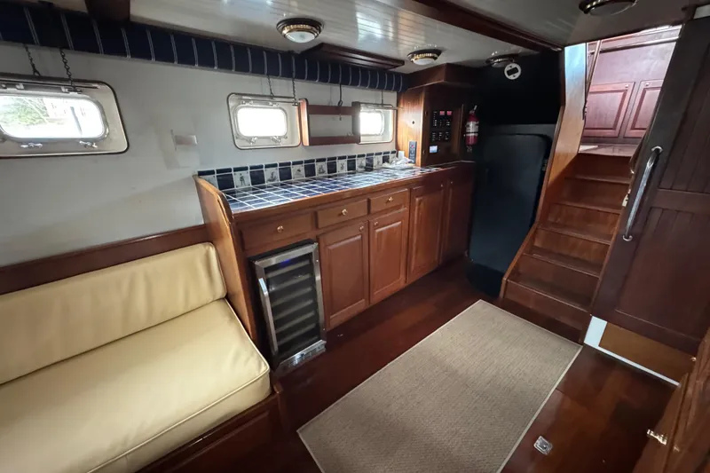 Slide: The Image of Interior of 1982 Custom Virpack Steel Hull yacht with wooden cabinetry and seating. - 31
