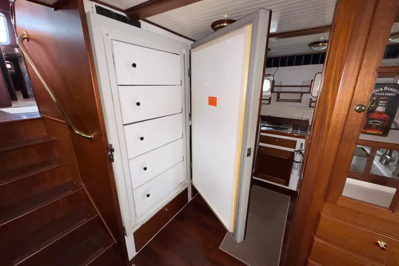 Slide: The Image of Interior of 1982 Custom Virpack Steel Hull boat with wooden cabinetry and open door. - 32