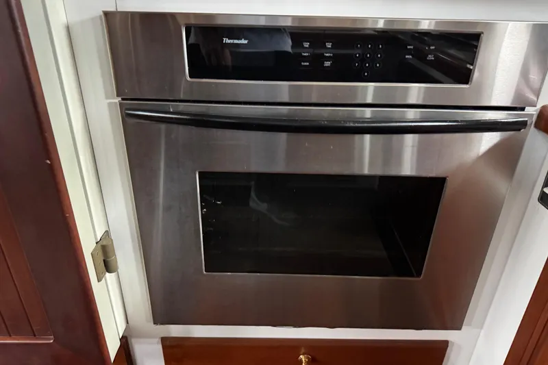 Slide: The Image of Stainless steel oven in a kitchen, featuring digital controls and sleek design. - 33