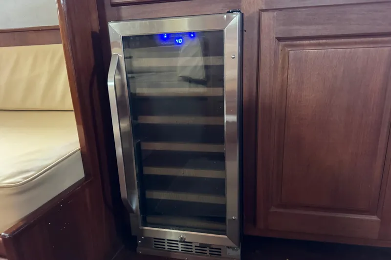 Slide: The Image of Wine cooler integrated into wooden cabinetry on a 1982 Custom Virpack Steel Hull boat. - 34