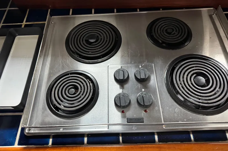 Slide: The Image of Stainless steel electric stove with four coil burners, Thermador brand, on a tiled countertop. - 35