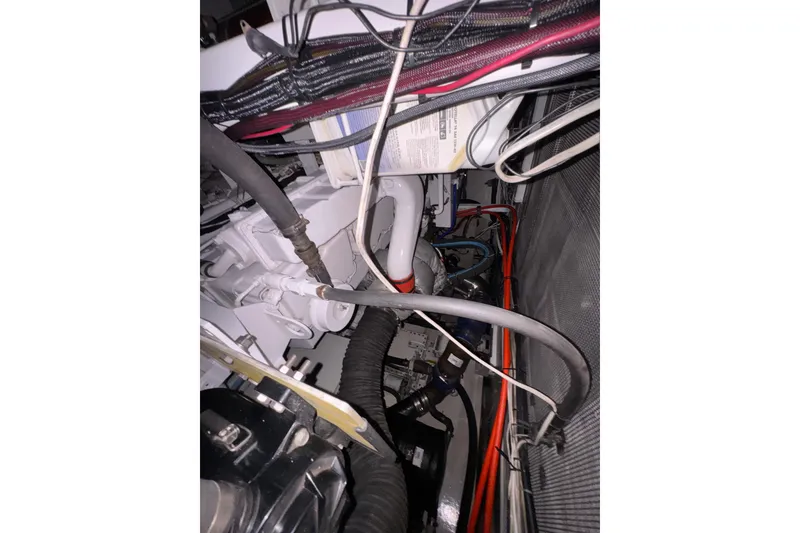 Slide: The Image of Engine compartment of a 1982 Custom Virpack Steel Hull with visible wiring and hoses. - 39