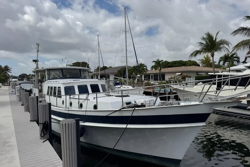 Slide: The Image of 1982 Custom Virpack Steel Hull yacht docked at marina under cloudy sky. - 4