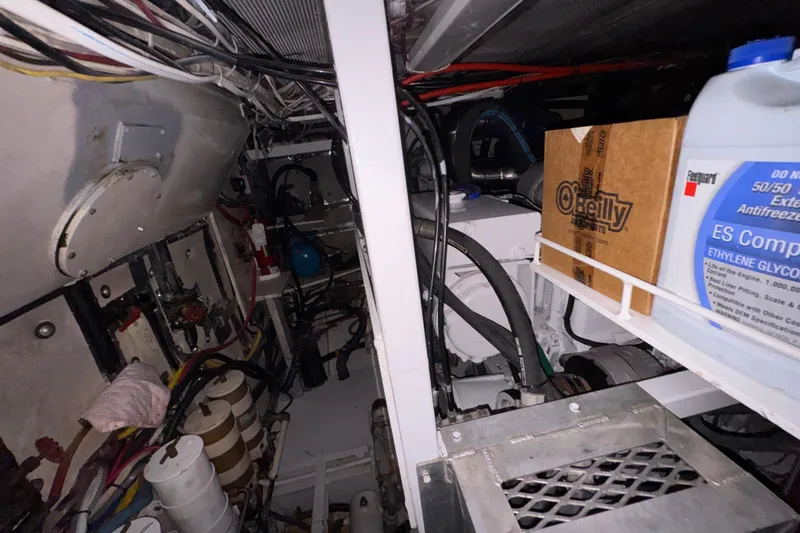 Slide: The Image of Engine room of 1982 Custom Virpack Steel Hull with wiring, antifreeze, and mechanical components. - 40