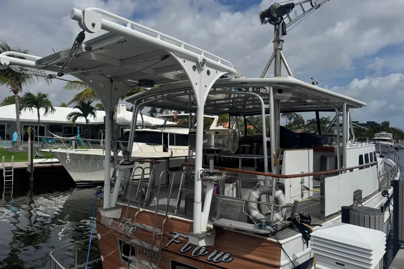 Slide: The Image of Custom 1982 Virpack Steel Hull boat docked, featuring a spacious deck and modern canopy. - 5