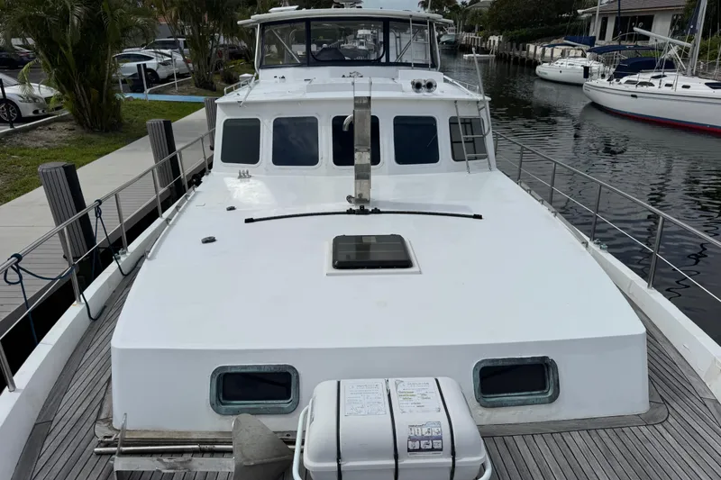 Slide: The Image of 1982 Custom Virpack Steel Hull boat docked by a canal, showcasing its sturdy design. - 7