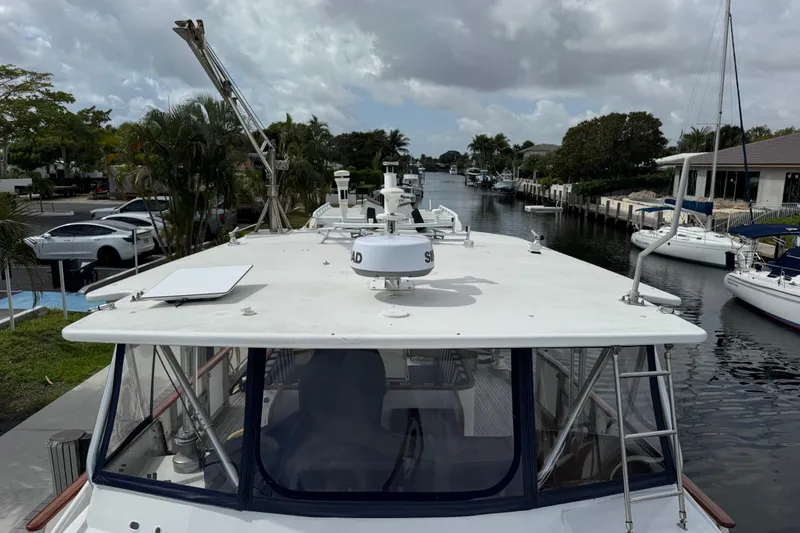 Slide: The Image of Custom 1982 Virpack Steel Hull boat docked in a scenic canal with surrounding yachts. - 8