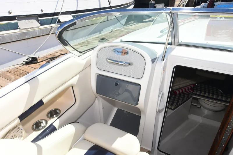 Slide: The Image of 2005 Chris-Craft Corsair 28 boat interior with seating and cabin view. - 10
