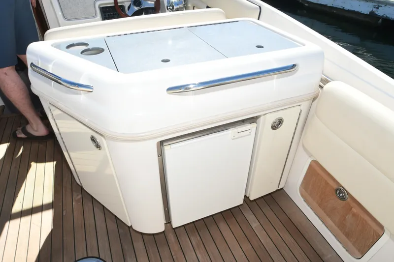 Slide: The Image of 2005 Chris-Craft Corsair 28 boat interior with sleek cabinetry and wooden flooring. - 11