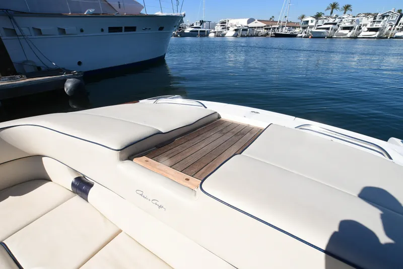 Slide: The Image of 2005 Chris-Craft Corsair 28 boat with cushioned seating, docked in a marina. - 14