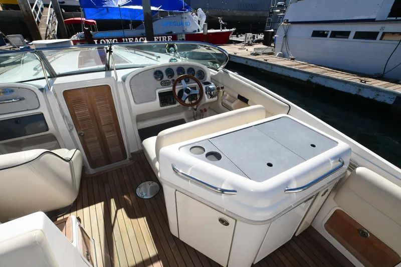 Slide: The Image of 2005 Chris-Craft Corsair 28 boat interior with steering wheel and seating area. - 15