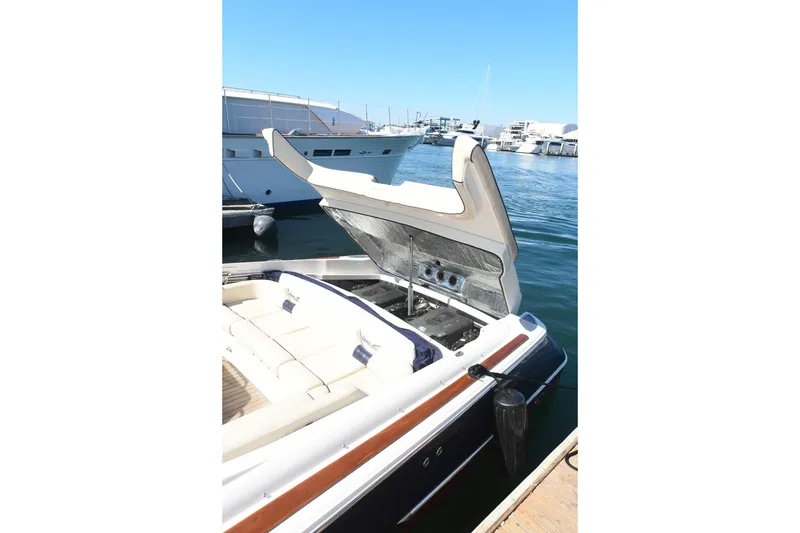 Slide: The Image of 2005 Chris-Craft Corsair 28 boat with open engine compartment at marina. - 16
