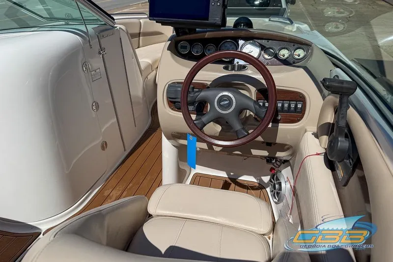 Slide: The Image of 2006 Chaparral Sunesta 274 boat interior with steering wheel and dashboard controls. - 10