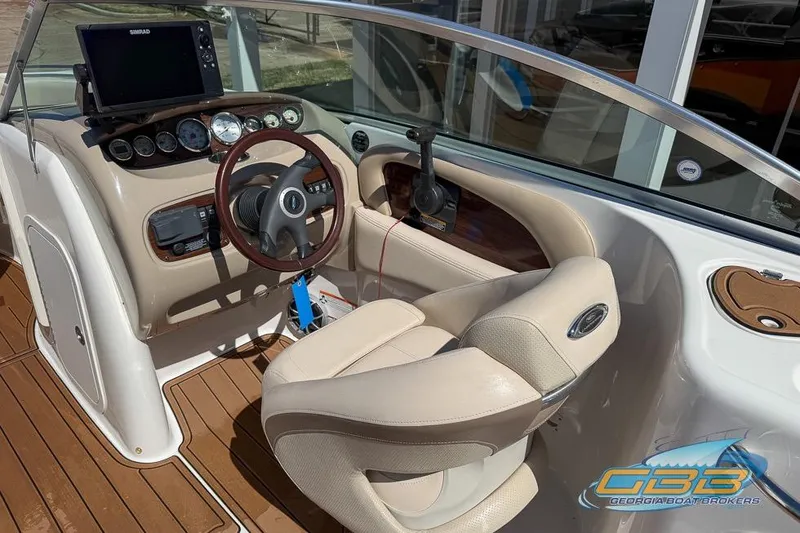 Slide: The Image of 2006 Chaparral Sunesta 274 boat cockpit with steering wheel and navigation system. - 11
