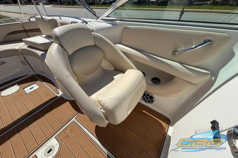 Slide: The Image of 2006 Chaparral Sunesta 274 boat interior with beige seating and wood flooring. - 13