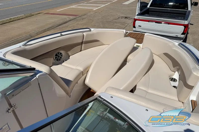 Slide: The Image of 2006 Chaparral Sunesta 274 boat interior with beige seating and speaker system. - 15