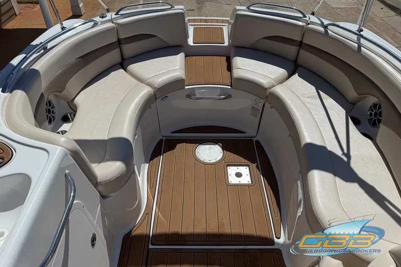 Slide: The Image of 2006 Chaparral Sunesta 274 boat interior with cushioned seating and wood-style flooring. - 19