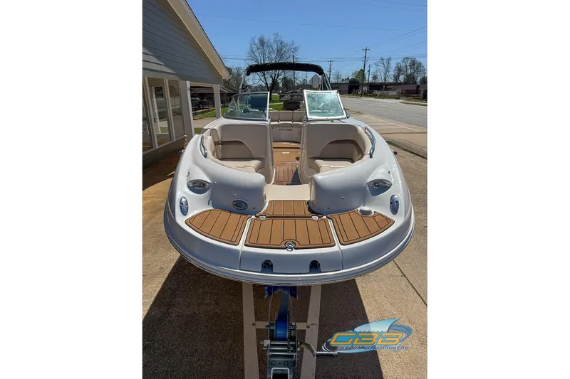 Slide: The Image of 2006 Chaparral Sunesta 274 boat with open deck and seating, displayed outdoors. - 20