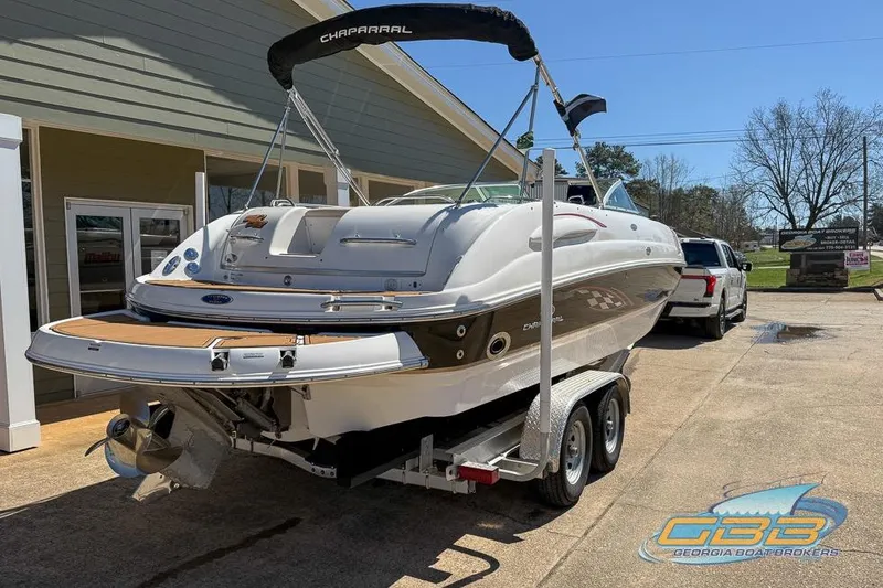 Slide: The Image of 2006 Chaparral Sunesta 274 boat on trailer, parked outside a building. - 22