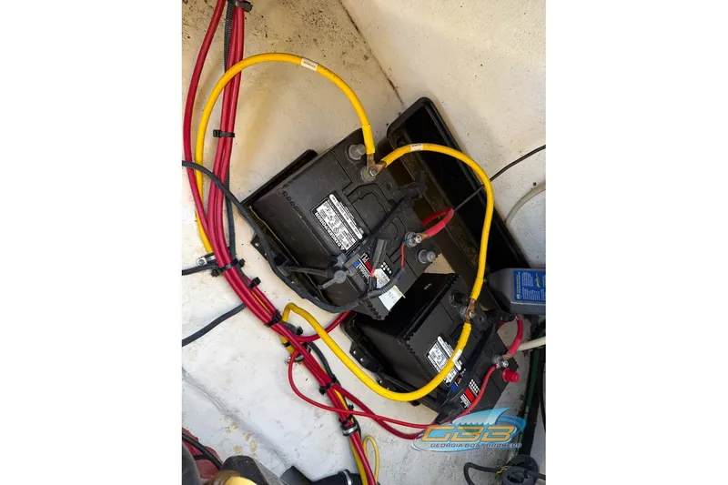 Slide: The Image of Battery setup in a 2006 Chaparral Sunesta 274 boat with red and yellow cables. - 29