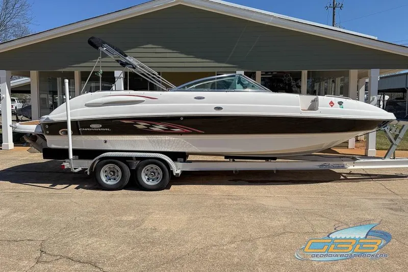Slide: The Image of 2006 Chaparral Sunesta 274 boat on trailer, parked outside a building. - 3