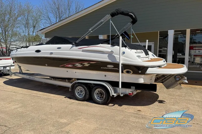 Slide: The Image of 2006 Chaparral Sunesta 274 boat on trailer, parked outdoors near a building. - 4