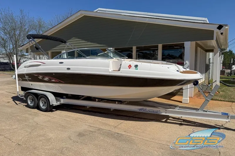 Slide: The Image of 2006 Chaparral Sunesta 274 boat on trailer outside a building. - 6
