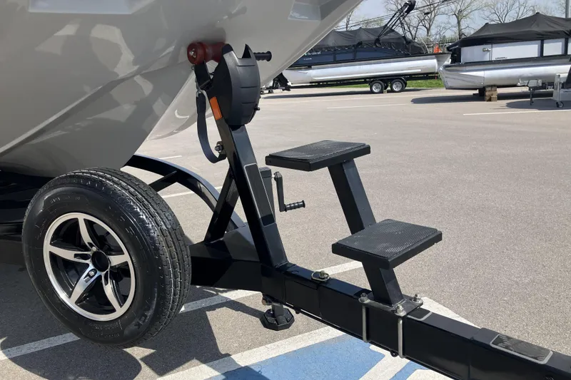 Slide: The Image of Trailer hitch and steps of a 2020 ATX Surf Boats 24 Type-S in a parking lot. - 12