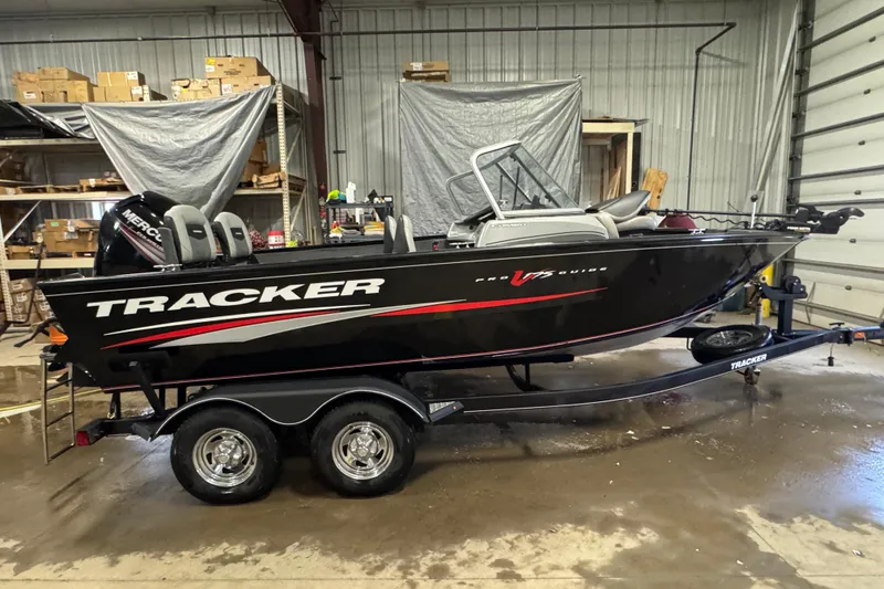 The Image of 2019 Tracker Pro Guide V-175 Combo boat on trailer in a garage setting. - 0