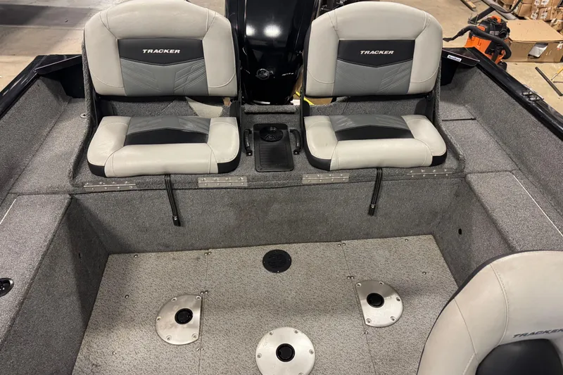 Slide: The Image of 2019 Tracker Pro Guide V-175 Combo boat interior with gray seating and carpeted flooring. - 11