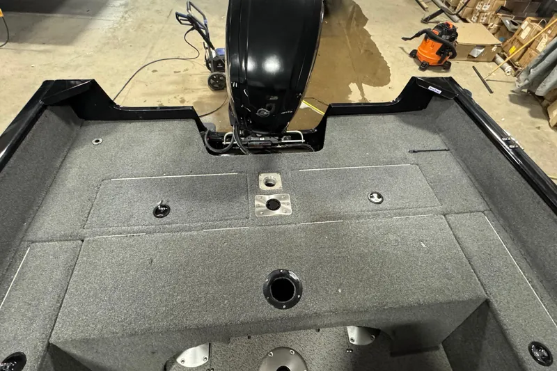 Slide: The Image of 2019 Tracker Pro Guide V-175 Combo boat interior with carpeted deck and motor. - 16