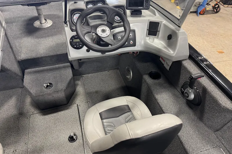 Slide: The Image of 2019 Tracker Pro Guide V-175 Combo boat interior with steering wheel and seat. - 6