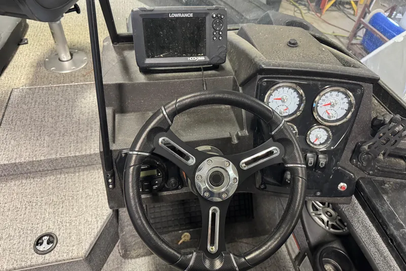 Slide: The Image of 2023 Tracker Targa V-19 WT dashboard with steering wheel and gauges. - 10