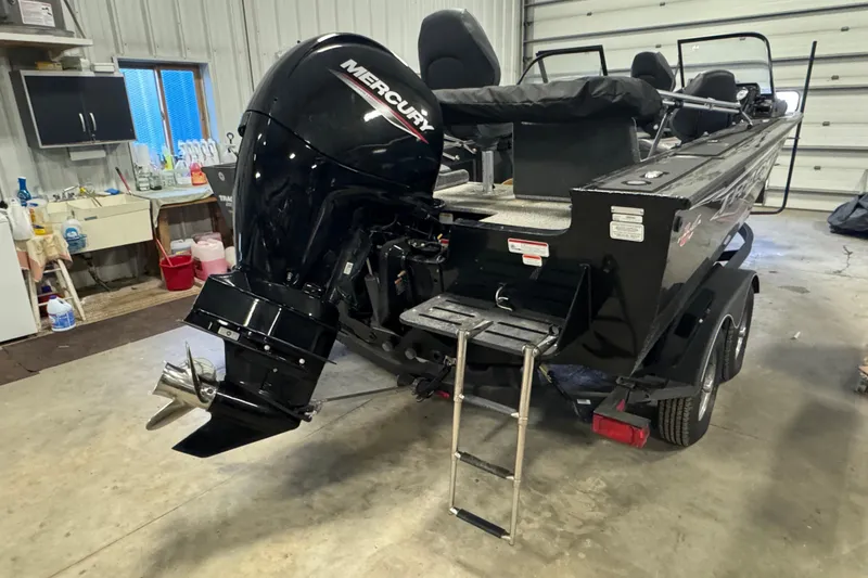 Slide: The Image of 2023 Tracker Targa V-19 WT boat with Mercury outboard motor in a garage setting. - 3