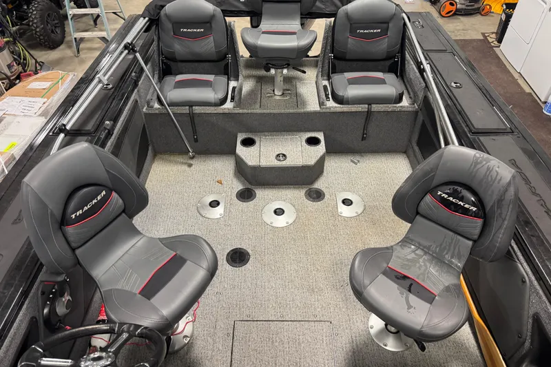 Slide: The Image of 2023 Tracker Targa V-19 WT boat interior with four cushioned seats in a garage setting. - 5