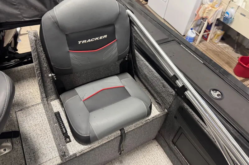 Slide: The Image of 2023 Tracker Targa V-19 WT boat seat with gray upholstery and red accents. - 8