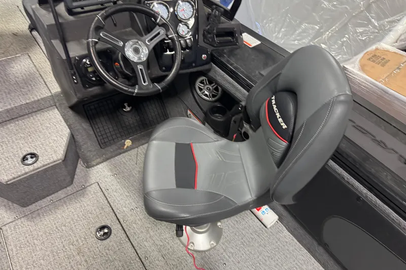 Slide: The Image of 2023 Tracker Targa V-19 WT boat interior with steering wheel and cushioned seat. - 9
