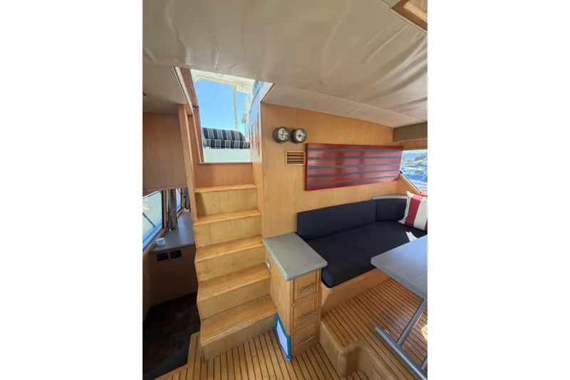 Slide: The Image of Interior of 1991 Ocean Alexander 520 Pilothouse with wooden stairs and cozy seating area. - 13