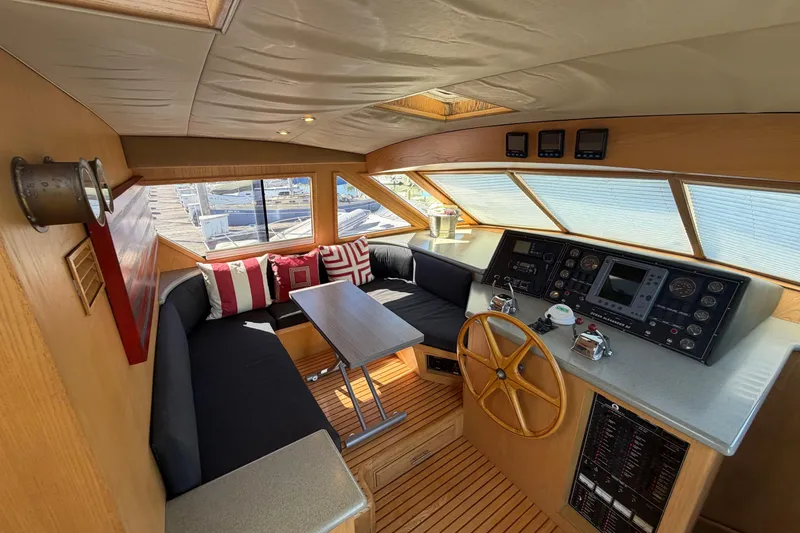 Slide: The Image of Pilothouse interior of 1991 Ocean Alexander 520, featuring helm, seating, and navigation equipment. - 14