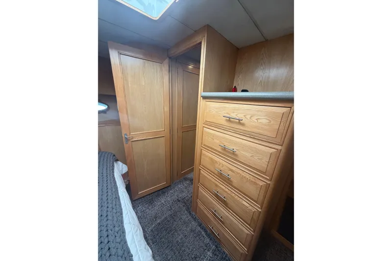 Slide: The Image of Interior of 1991 Ocean Alexander 520 Pilothouse with wooden cabinetry and carpeted flooring. - 18