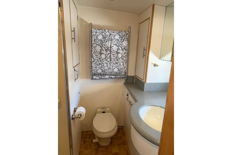 Slide: The Image of Bathroom interior of 1991 Ocean Alexander 520 Pilothouse yacht, featuring toilet and sink. - 19