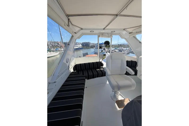 Slide: The Image of Interior view of 1991 Ocean Alexander 520 Pilothouse with seating and marina backdrop. - 23