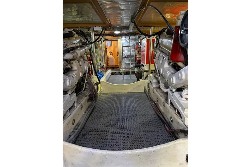 Slide: The Image of Engine room of 1991 Ocean Alexander 520 Pilothouse yacht, showcasing dual engines and equipment. - 31